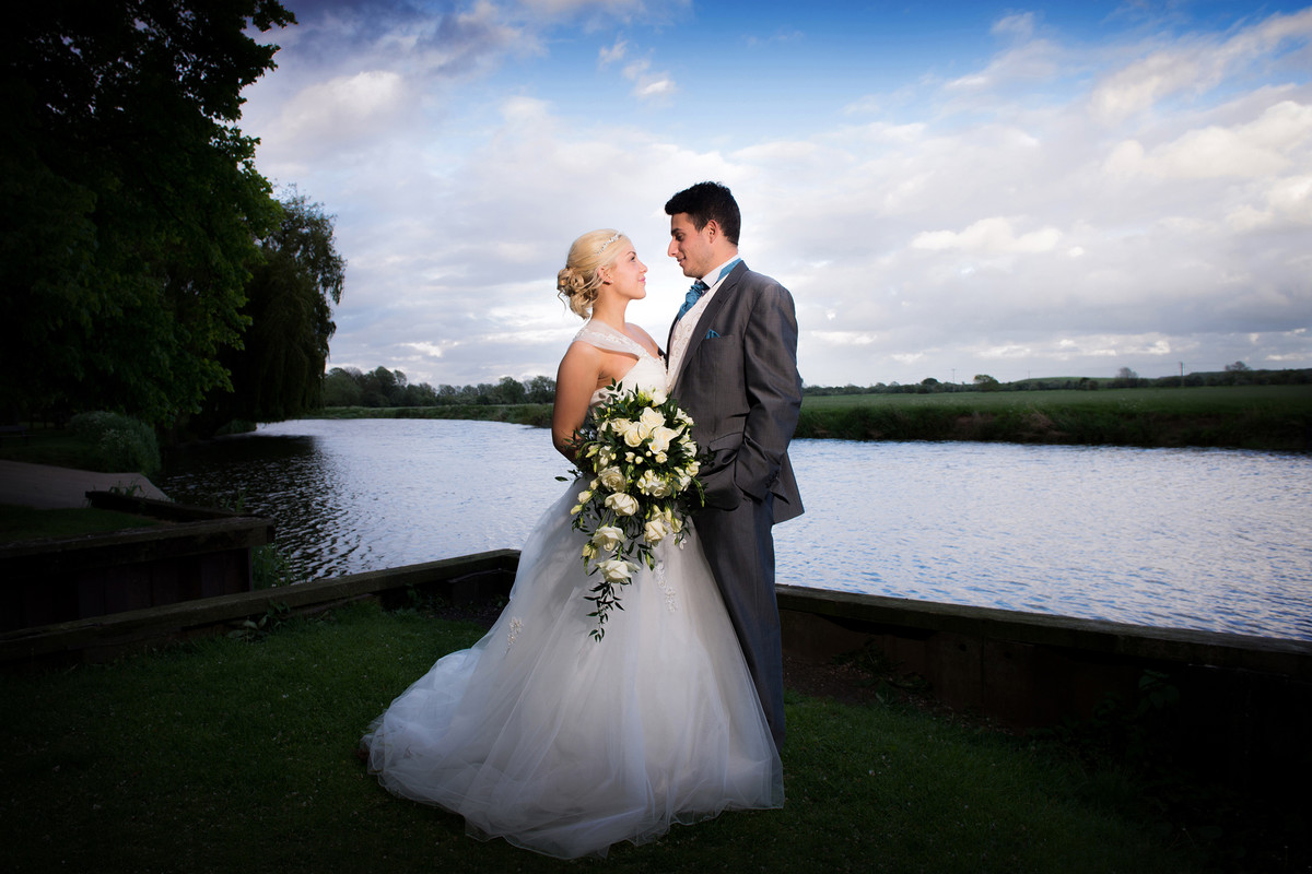 Bride and groom by the river