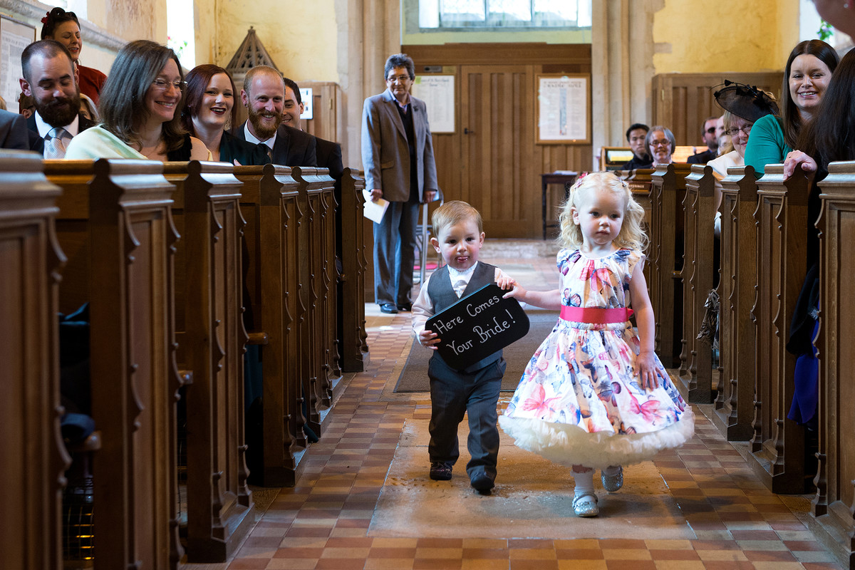 two small children walking down the aisle