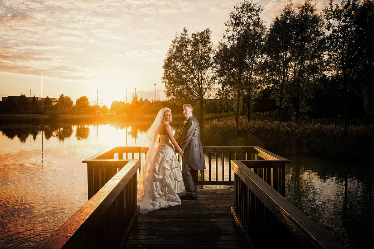 Bride and groom sunset over a lake